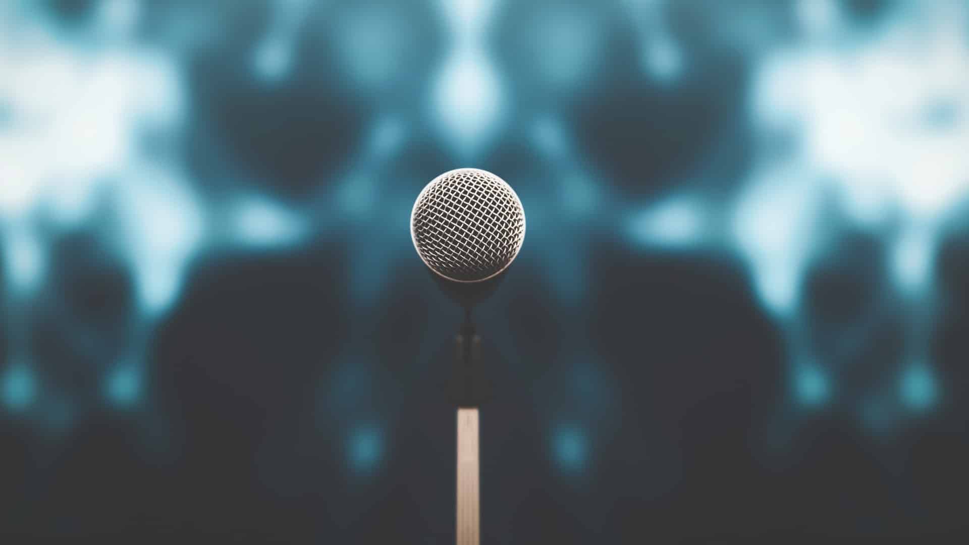 Microphone with stage light background for performance concept of speech comment and public speaking